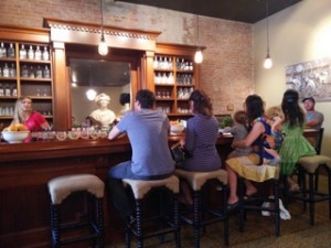 Kim sidles up to the bar with 2 kids attached